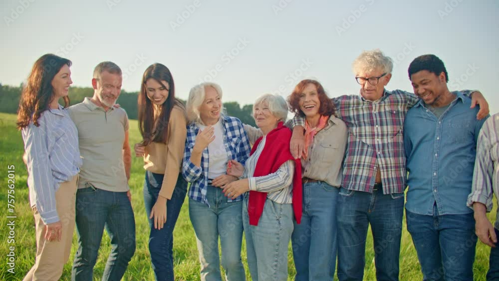 Multi-ethnic group of people standing next to each other and posing for perfect shot. Hugging each other. Smiling at dog in front of them. Open air activity. Getting back together. Multi-ethnic group of people standing next to each other and posing for perfect shot. Hugging each other. Smiling at dog in front of them. Open air activity. Getting back together.