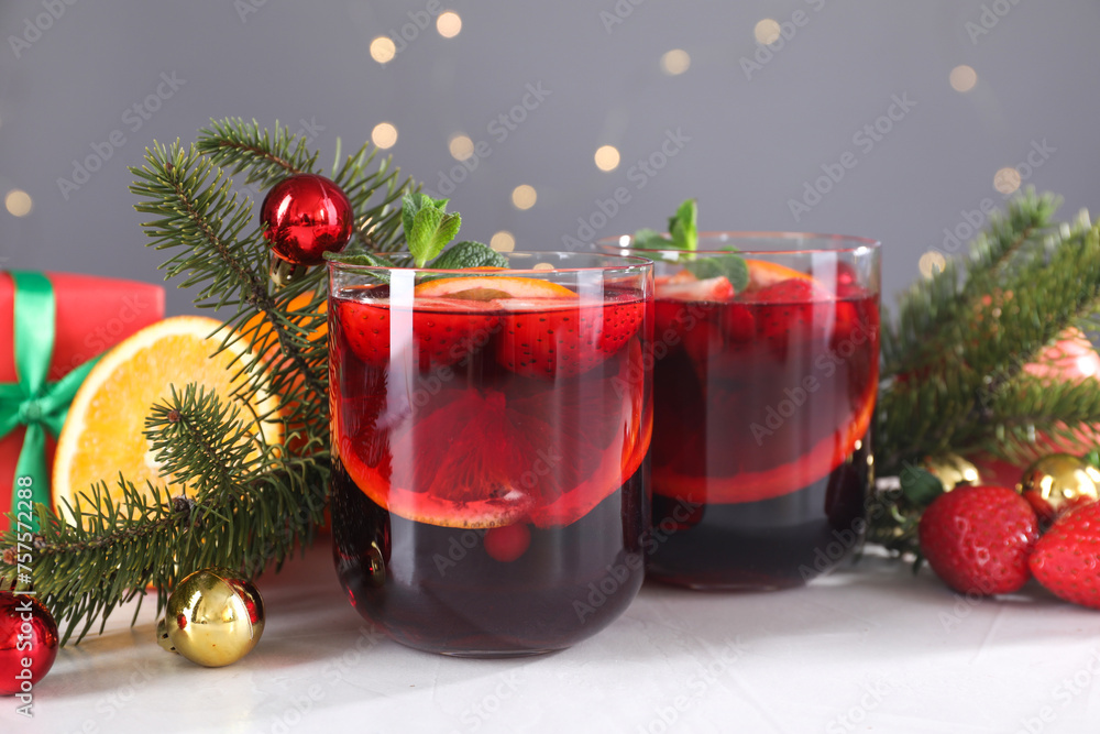 Aromatic Christmas Sangria in glasses and festive decor on white table, closeup Aromatic Christmas Sangria in glasses and festive decor on white table, closeup