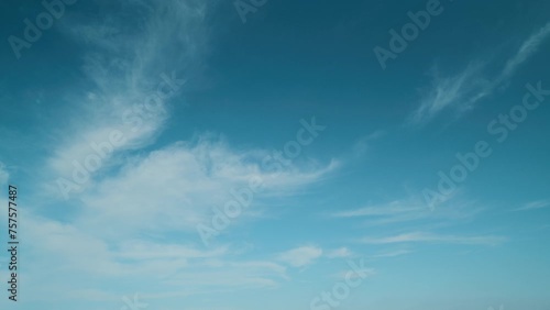 Beautiful cirrus clouds visible in blue sky. Translucent cirrus spindrift clouds high up. photo