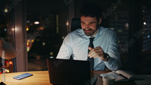 Distressed businessman looking computer worried problem at night office close up