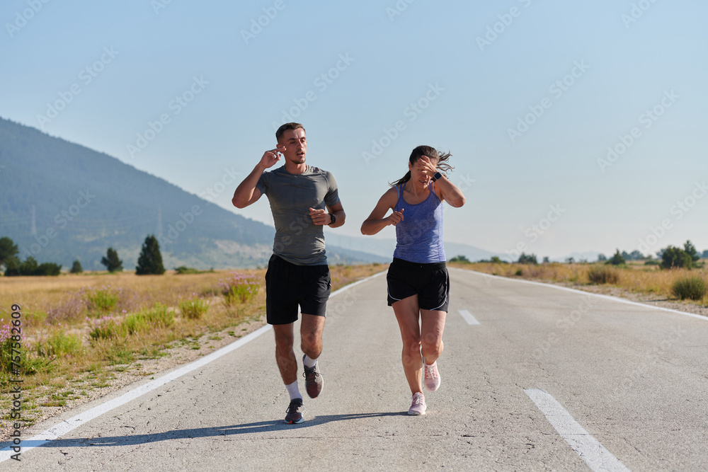 Energized by the beauty of nature, a couple powers through their morning run, their bodies and spirits invigorated. Energized by the beauty of nature, a couple powers through their morning run, their bodies and spirits invigorated.
