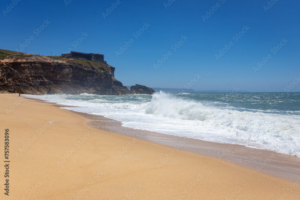 North Beach famous for giant waves in Nazare town on so called Silver Coast, Oeste region of Portugal, view with fort of Saint Michael the Archangel