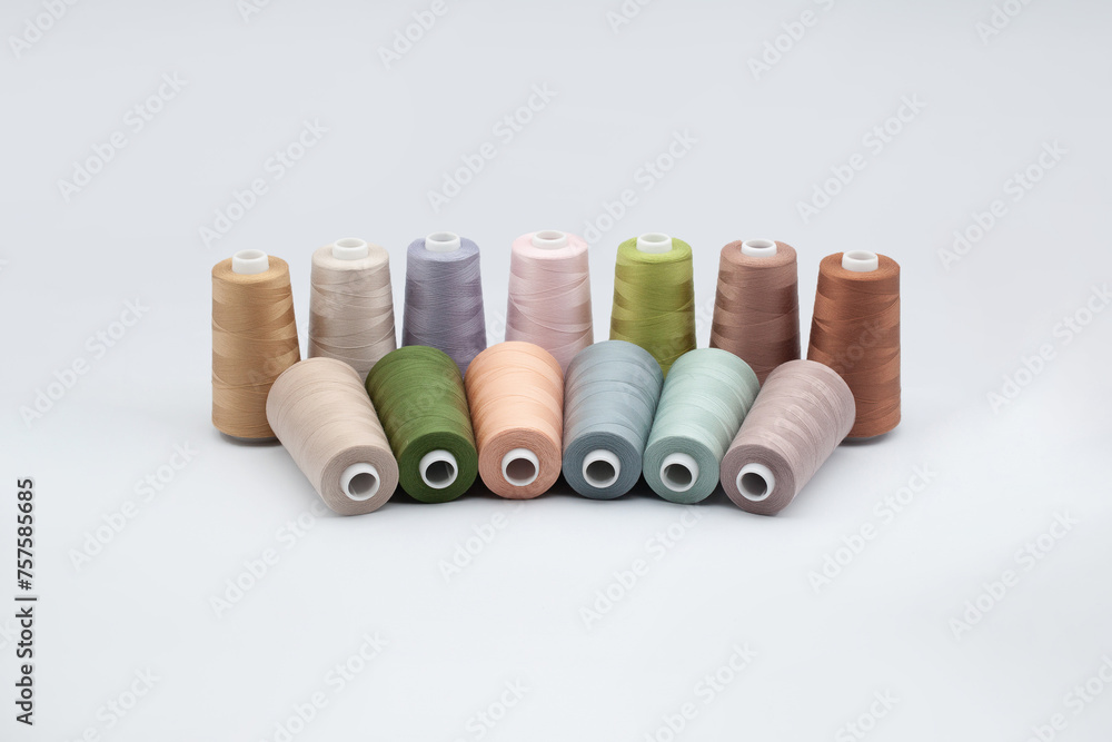 Thread spools background. Various colors sewing kit. Collection of threads. Pale pastel colors. Sew threads. Colorful hobby background. Tailor shop texture. Isolated on white. Thread spools background. Various colors sewing kit. Collection of threads. Pale pastel colors. Sew threads. Colorful hobby background. Tailor shop texture. Isolated on white.