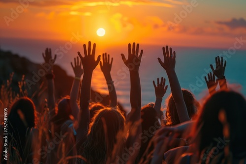 Hands to heaven, group of people with their hands up looking at the sunset  © TheNoteTravel