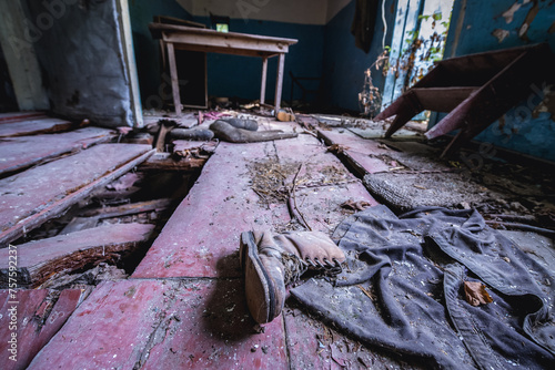 Old shoe in house in abandoned Stechanka village in Chernobyl Exclusion Zone, Ukraine photo