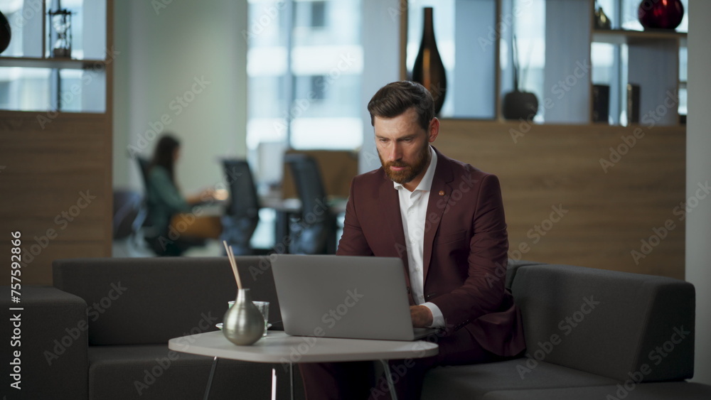 Focused businessman working laptop sitting office. Pensive worker typing device Focused businessman working laptop sitting office. Pensive worker typing device