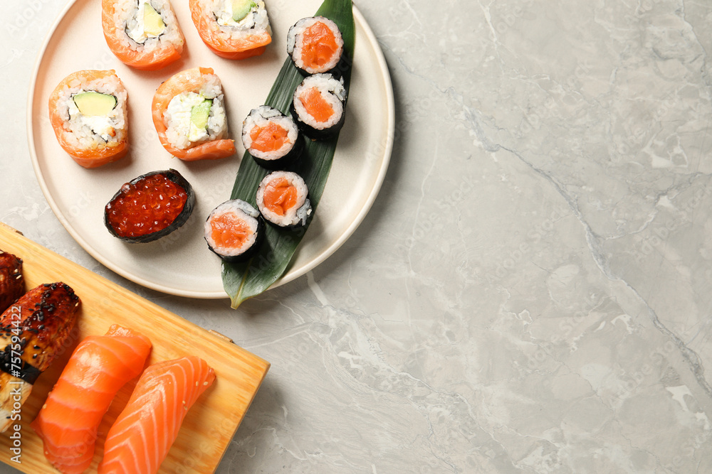 Delicious sushi rolls on light grey marble table, flat lay. Space for text Delicious sushi rolls on light grey marble table, flat lay. Space for text