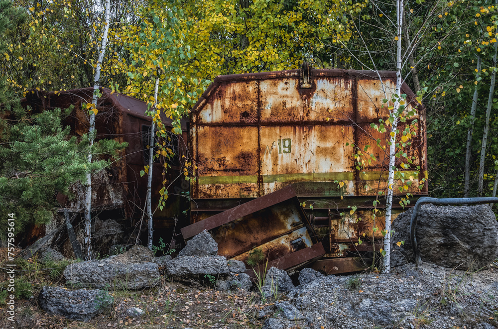 Old wagon near Unfinished cooling tower of reactor 5 of Chernobyl Nuclear Power Plant in Chernobyl Exclusion Zone, Ukraine Old wagon near Unfinished cooling tower of reactor 5 of Chernobyl Nuclear Power Plant in Chernobyl Exclusion Zone, Ukraine