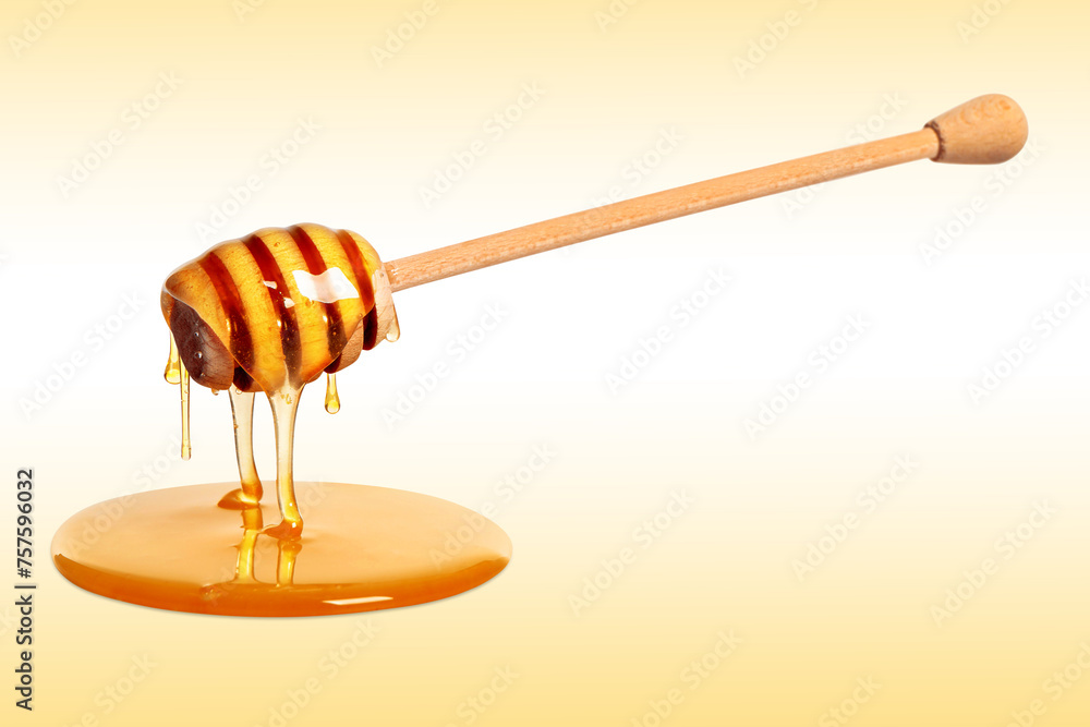 Natural honey dripping from dipper on pale yellow background Natural honey dripping from dipper on pale yellow background