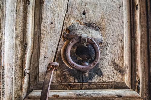 Wooden door with knocker in Church of the Holy Sepulchre in Christian Quarter of Old City of Jerusalem, Israel