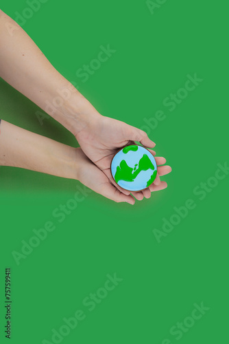 Earth Day concept. Сookie in shape of Earth in hand.