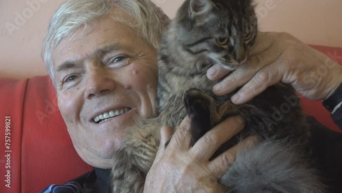 Portrait of elderly man caressing his cat