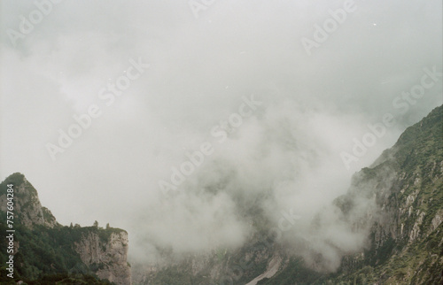 mountain view with peaks and clouds and fog