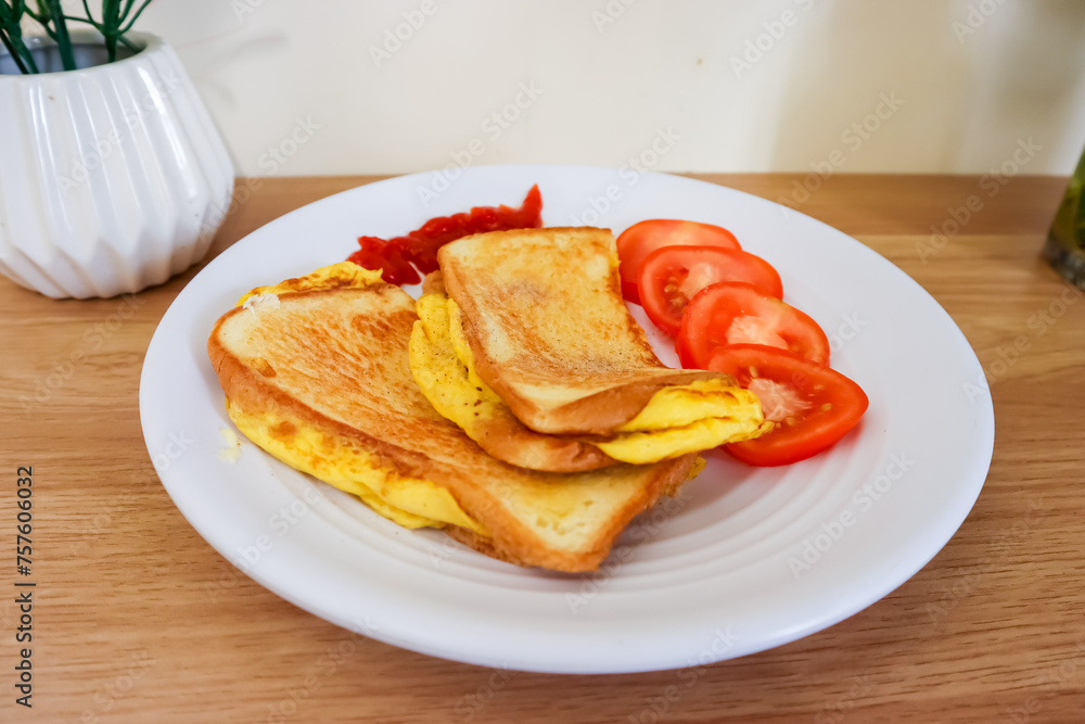 Simple breakfast menu, bread toast with egg and tomato Simple breakfast menu, bread toast with egg and tomato