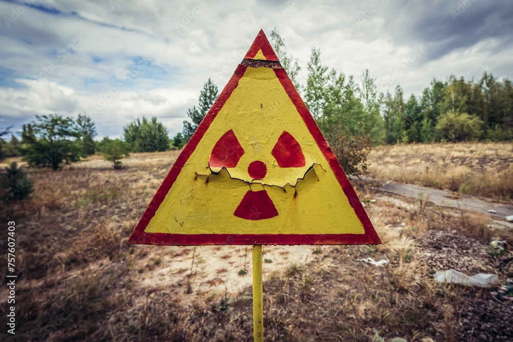Radiation warning sign on a cemetery in Pripyat abandoned city, Chernobyl Exclusion Zone, Ukraine