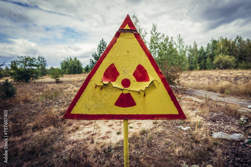 Radiation warning sign on a cemetery in Pripyat abandoned city, Chernobyl Exclusion Zone, Ukraine