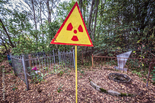 Radiation warning sign on a cemetery in Pripyat abandoned city in Chernobyl Exclusion Zone, Ukraine
