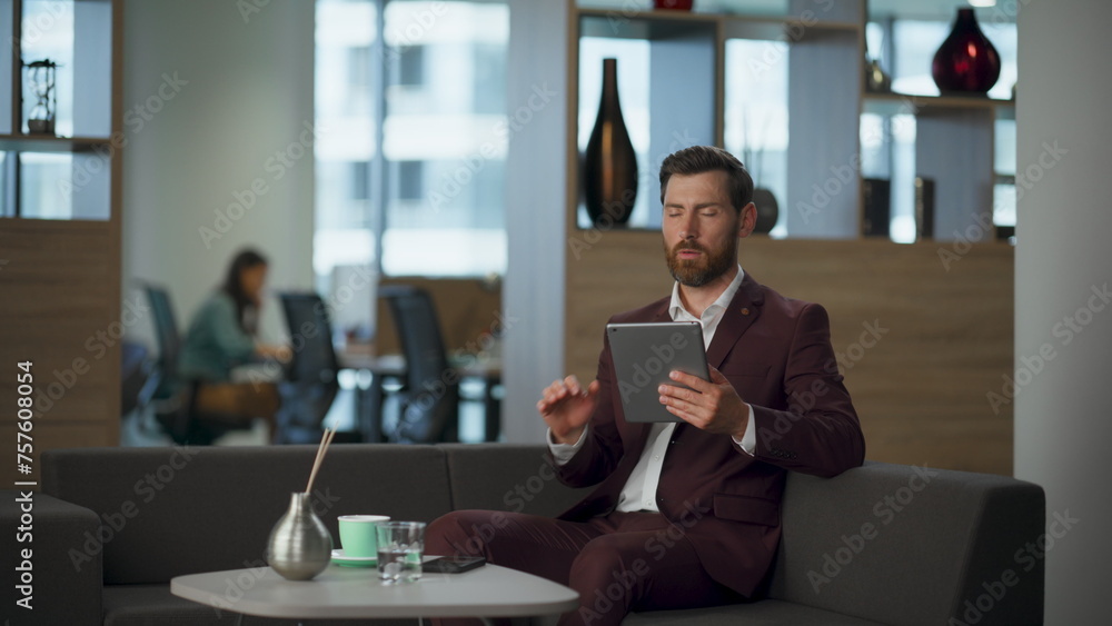 Tired lawyer working tablet computer in office. Entrepreneur touching screen Tired lawyer working tablet computer in office. Entrepreneur touching screen