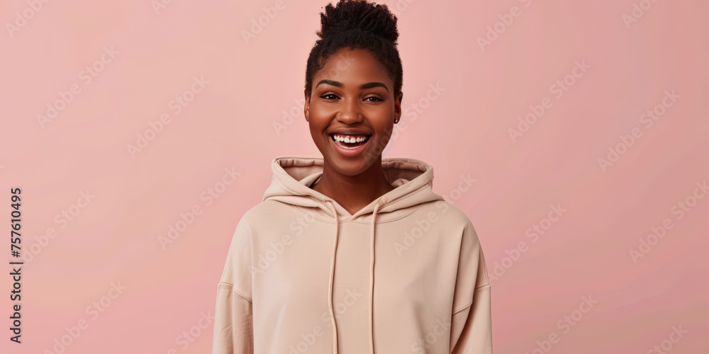 E-commerce photography of a happy woman model wearing a light tan hoodie, solid color background, hands slightly out of scene, focal point is the front of the hoodie E-commerce photography of a happy woman model wearing a light tan hoodie, solid color background, hands slightly out of scene, focal point is the front of the hoodie