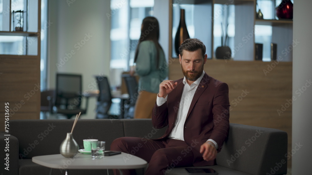 Serious manager grabbing tablet computer in office interior. Modern work concept Serious manager grabbing tablet computer in office interior. Modern work concept