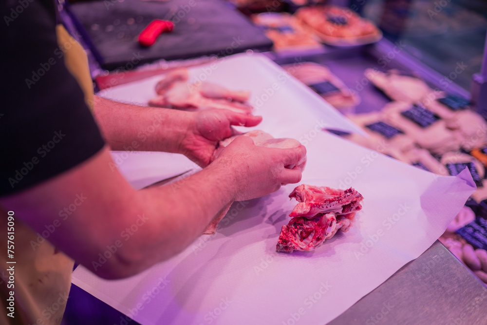 Closeup of Butcher's Hands Preparing Meat Order for Customer in Butcher Shop
