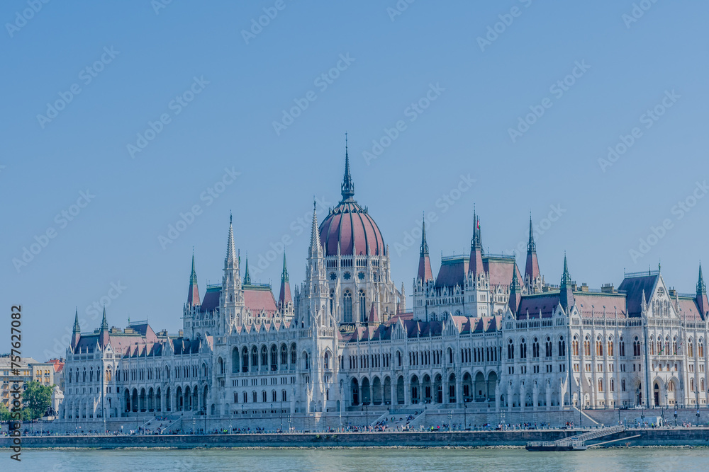 The Hungarian Parliament Building beside the Danube on a sunny day with clear skies, in Budapest, Hungary