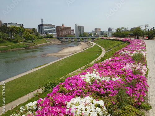 A walking course with colorful flowers along the river                                                         