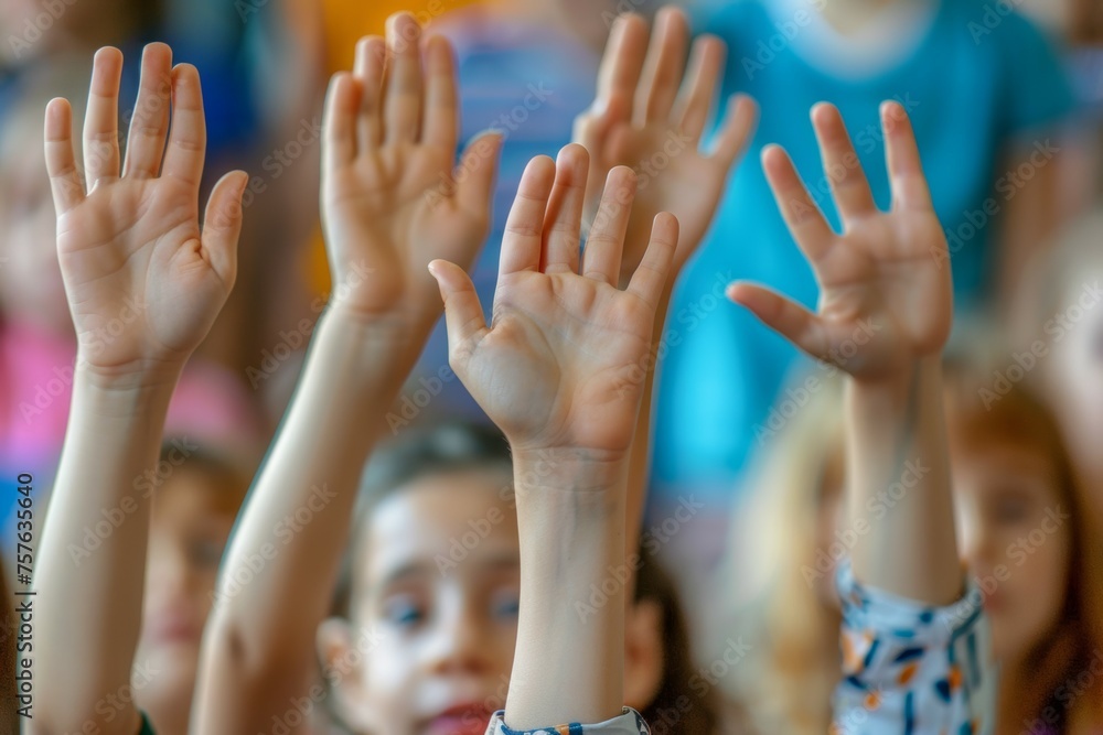 A group of children are raising their hands in the air A group of children are raising their hands in the air