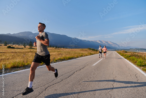 A group of friends maintains a healthy lifestyle by running outdoors on a sunny day, bonding over fitness and enjoying the energizing effects of exercise and nature © .shock