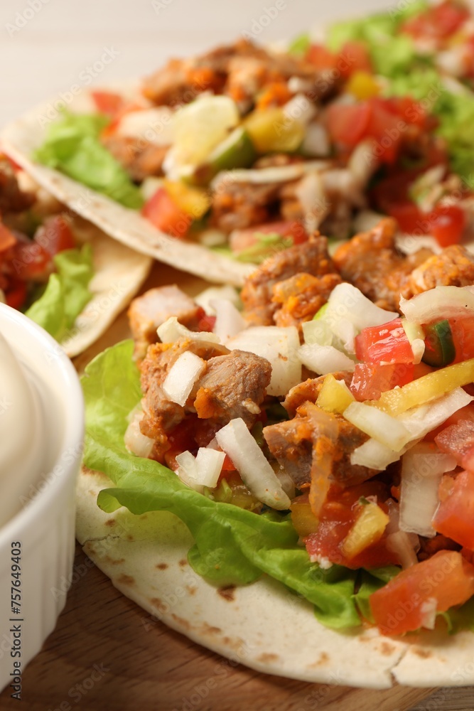 Delicious tacos with vegetables and meat on table, closeup Delicious tacos with vegetables and meat on table, closeup