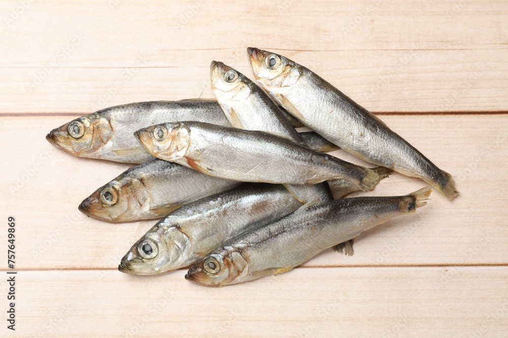 Fresh raw sprats on light wooden table, top view Fresh raw sprats on light wooden table, top view