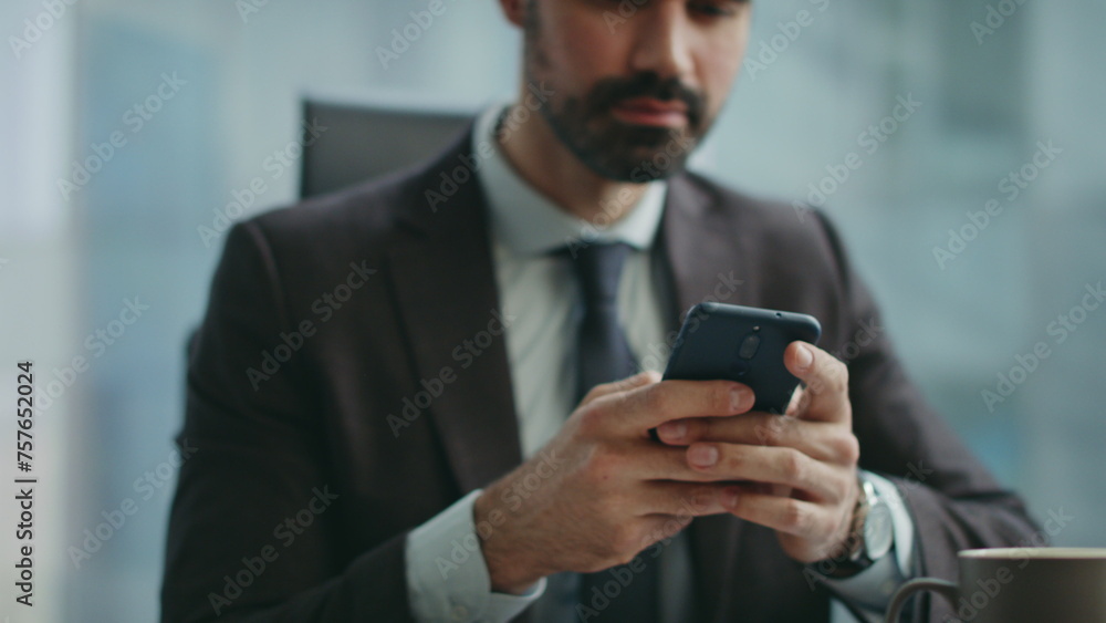 Positive manager messaging telephone sitting office closeup. Worker reading sms Positive manager messaging telephone sitting office closeup. Worker reading sms