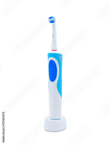 Electric toothbrush standing upright isolated on a white background