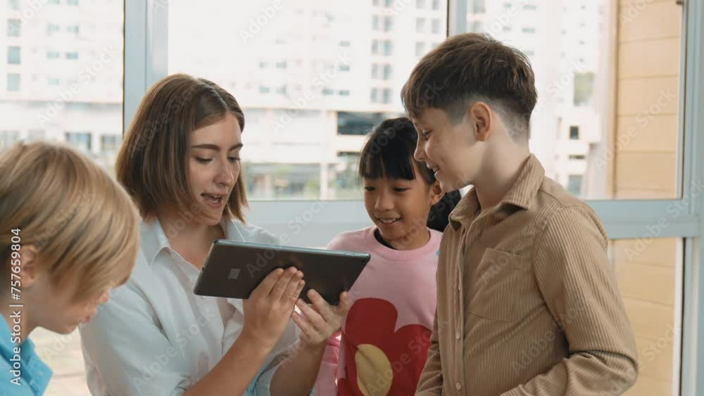 Smart teacher holding tablet while open online lesson to group of ...