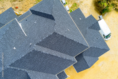 There are asphalt shingles covering roof of newly constructed house photo