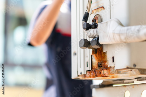 Air conditioner technician checking leaks in conditioning systems, Repairman service for repair and maintenance of air conditioners
