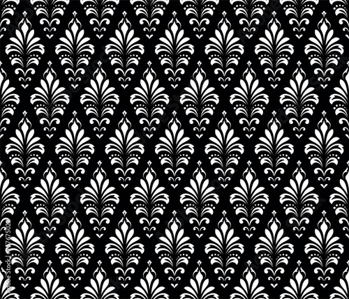 Wallpaper in the style of Baroque. Seamless vector background. White and black floral ornament. Graphic pattern for fabric, wallpaper, packaging. Ornate Damask flower ornament.