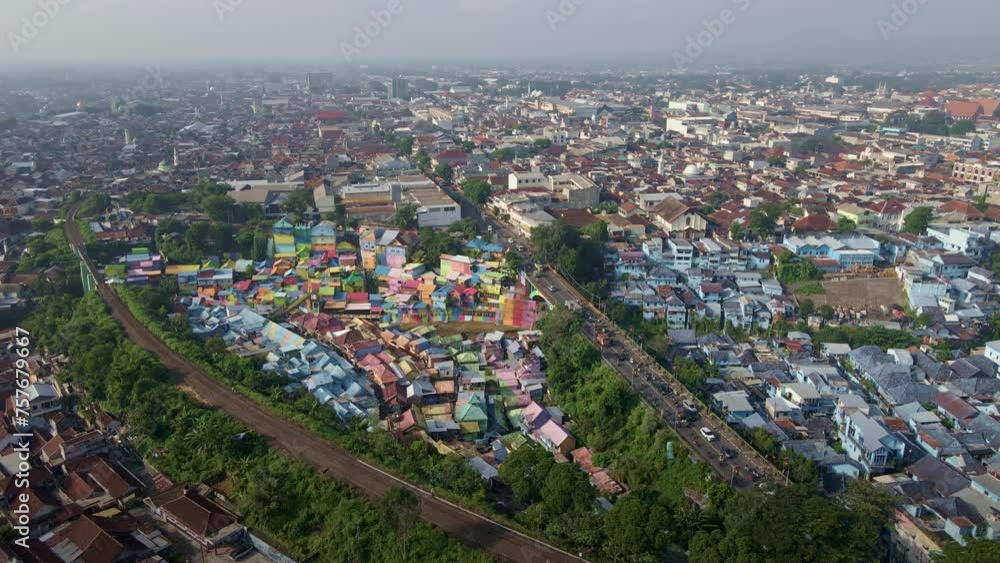 Controversial slum tourism in the downtown of the second biggest city of East Java, Malang, Indonesia, is situated side by side with the railway track and bustling traffic amidst an overpopulated area Controversial slum tourism in the downtown of the second biggest city of East Java, Malang, Indonesia, is situated side by side with the railway track and bustling traffic amidst an overpopulated area
