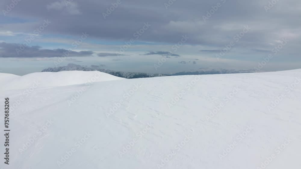 Expansive snowy landscape with Piatra Craiului Mountains backdrop, Iezer-Papusa, Arges Expansive snowy landscape with Piatra Craiului Mountains backdrop, Iezer-Papusa, Arges