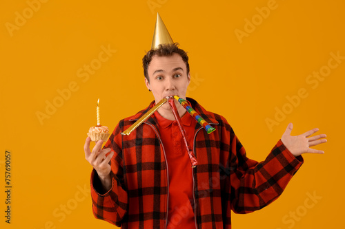 Young man with birthday cak...