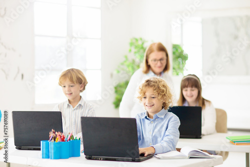 Online remote learning. School kids with computer.