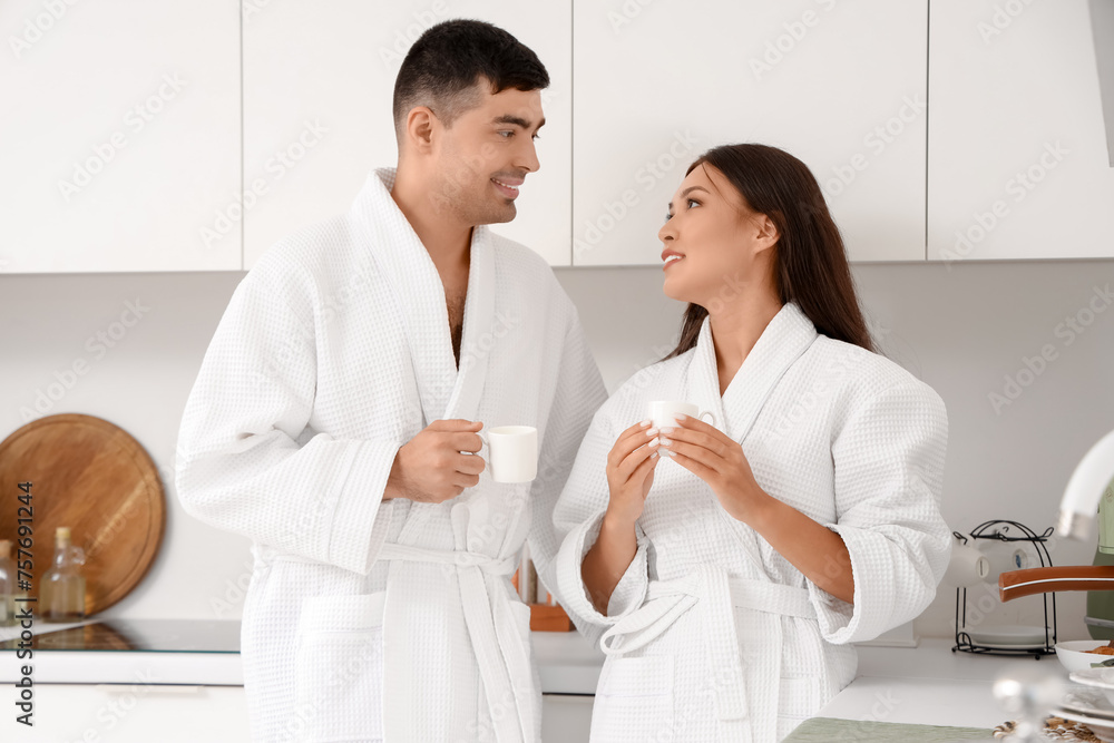 Happy young couple drinking coffee in kitchen Happy young couple drinking coffee in kitchen