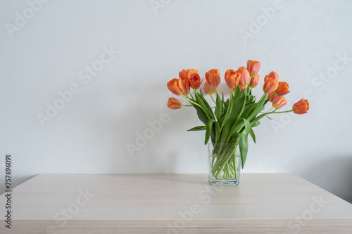 Wallpaper Mural Orange tulips in a glass vase on the table. Copy space. Torontodigital.ca