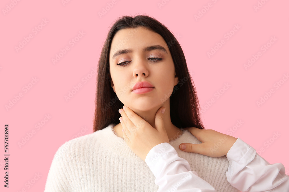 Endocrinologist examining thyroid gland of young woman on pink background Endocrinologist examining thyroid gland of young woman on pink background