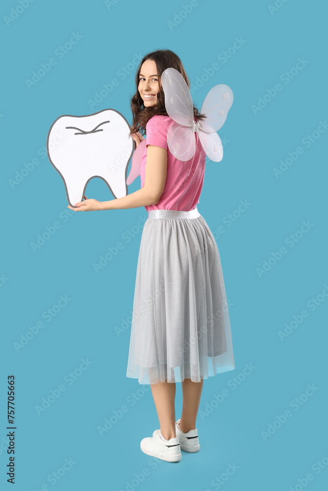 Tooth Fairy with paper figure on blue background Tooth Fairy with paper figure on blue background
