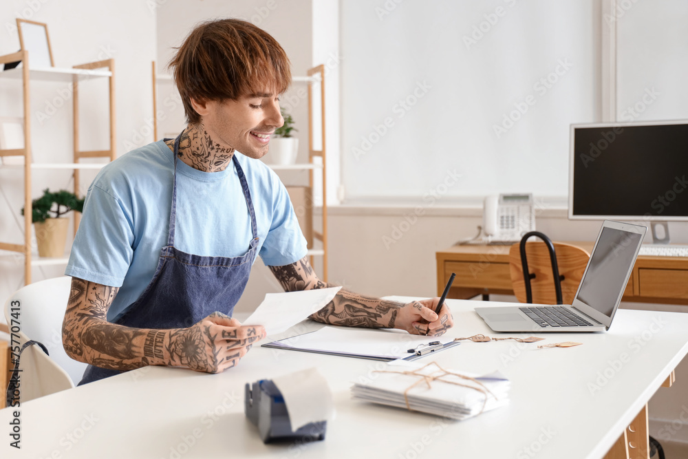 Young online store seller working at table in warehouse Young online store seller working at table in warehouse