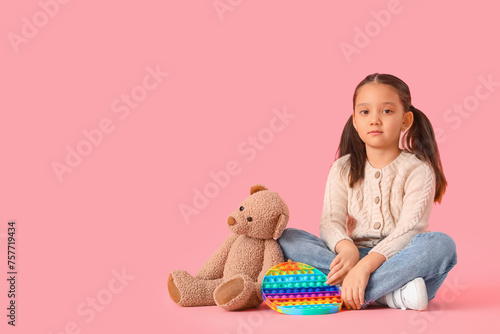Little Asian girl with bear...