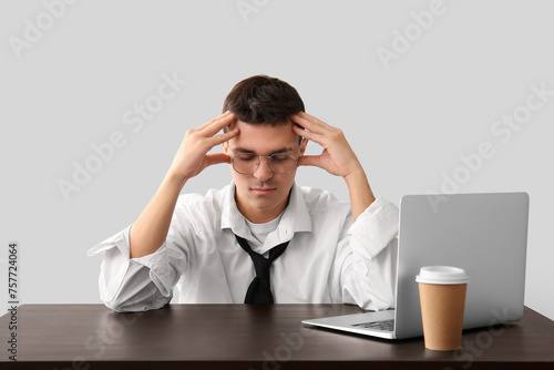 Tired young businessman at ...