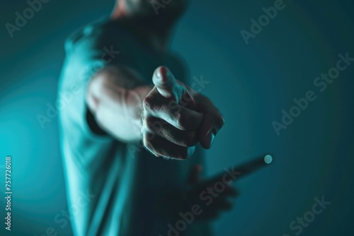 Man is pointing at cell phone with cigarette in his hand