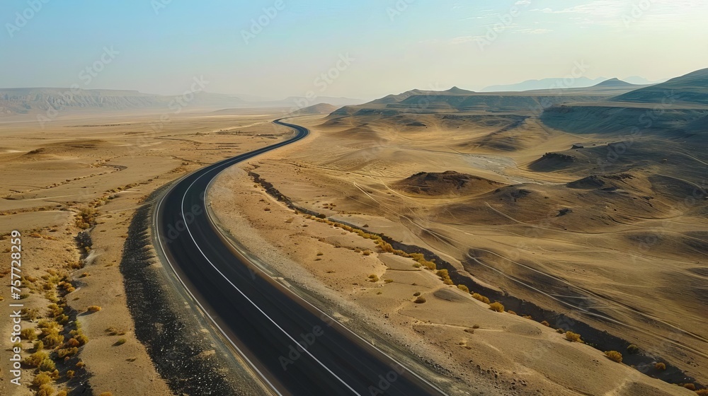 Empty asphalt road winding through a vast desert landscape, symbolizing adventure and exploration Empty asphalt road winding through a vast desert landscape, symbolizing adventure and exploration